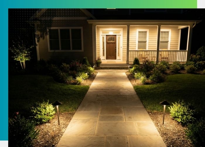 Stone walkway illuminated by small black landscape path lights